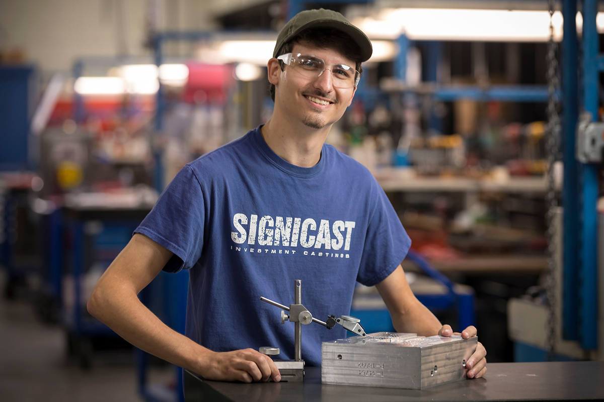 young man in blue shirt with component