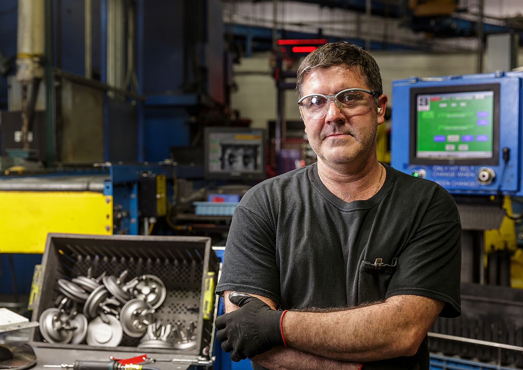 male signicast worker in front of components